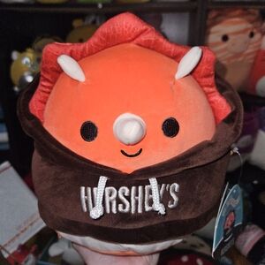 NWT Tristan Orange Triceratops Dinosaur Squishmallow wearing Hershey’s Hoodie